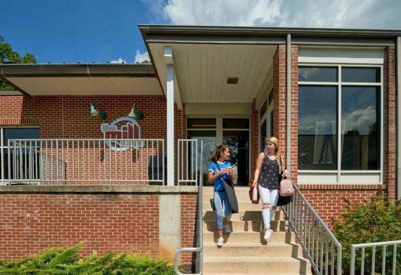 Mill Cafe exterior entrance with students walking down steps