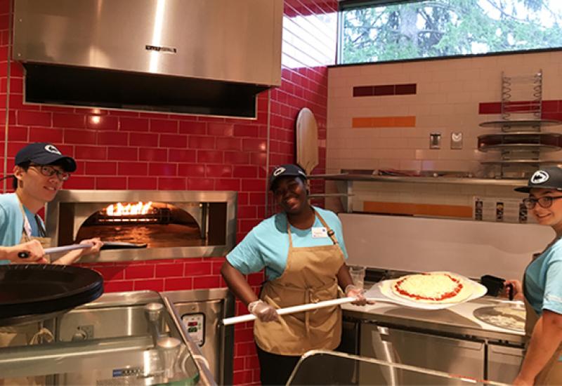 Student employees at the wood-fired pizza oven