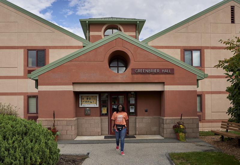Student standing in front of Greenbrier Hall
