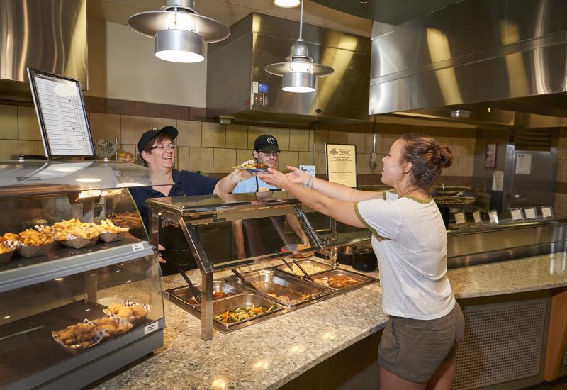 Staff helping a guest at the Homestyle station in Cafe Metro