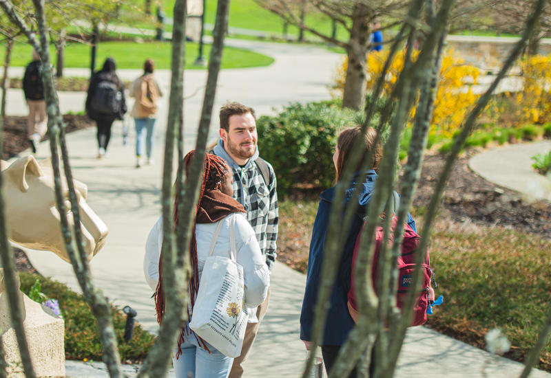 Students standing near the Lion Shrine at Berks campus