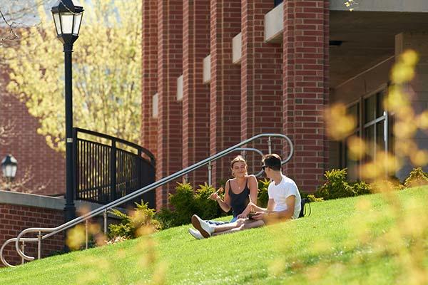Students visit on lawn by South Halls