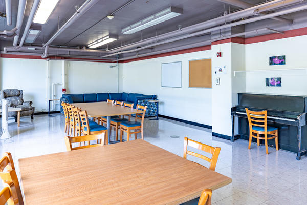 Pollock Mifflin Hall room with tables and a piano