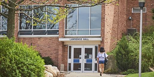 Lawrence Hall Exterior with female student walking