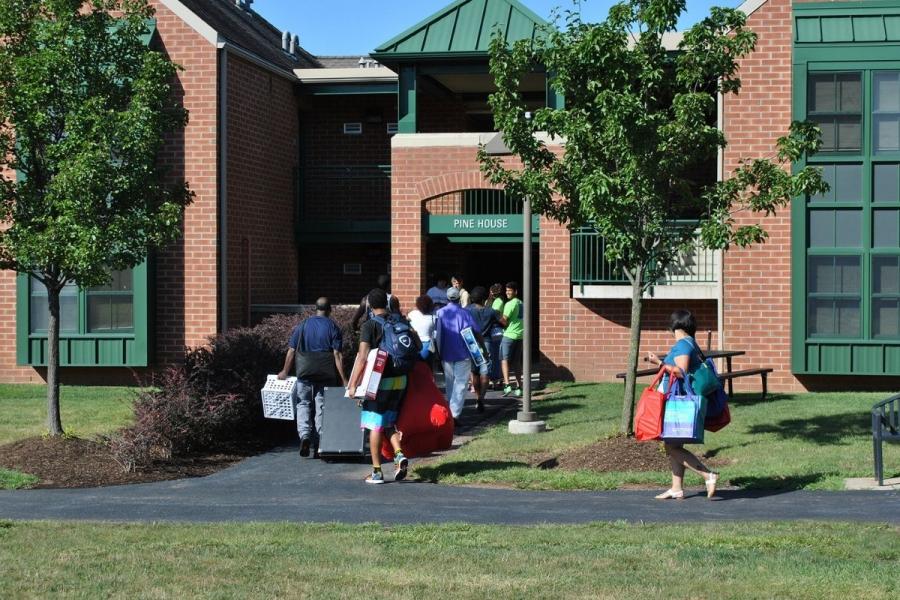 Pine House exterior with students moving in