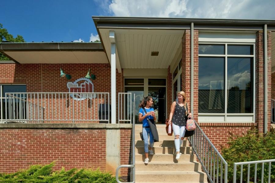 Mill Cafe exterior entrance with students walking down steps