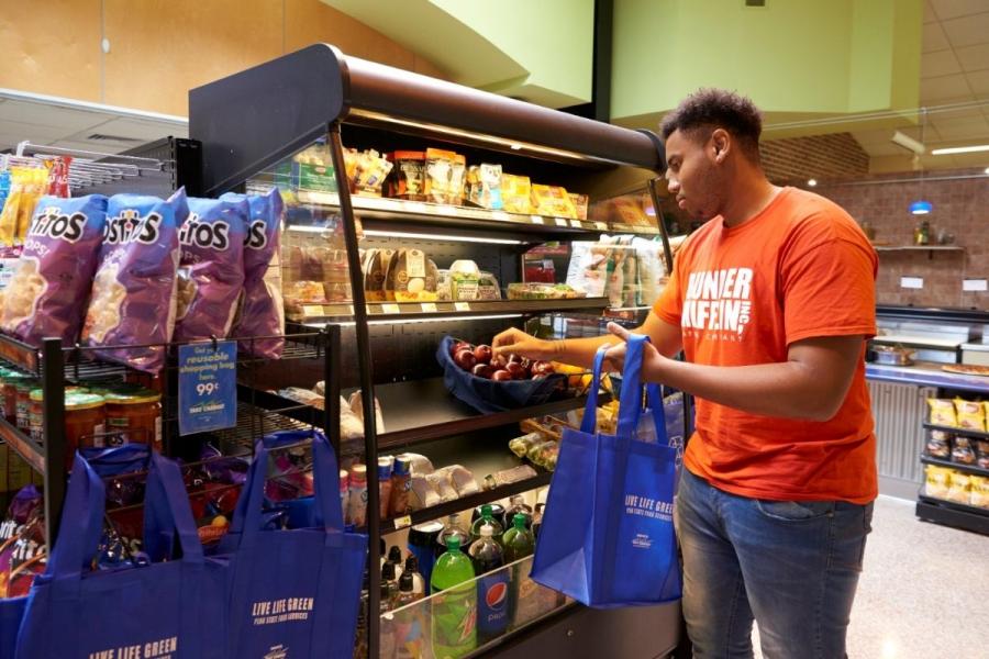 Student shopping for produce at Mill Cafe