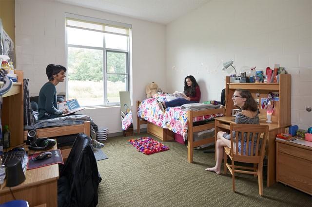 Juniata rom with three students chatting