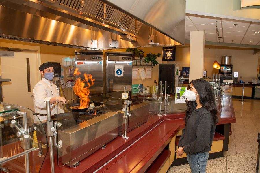Chef cooking for student