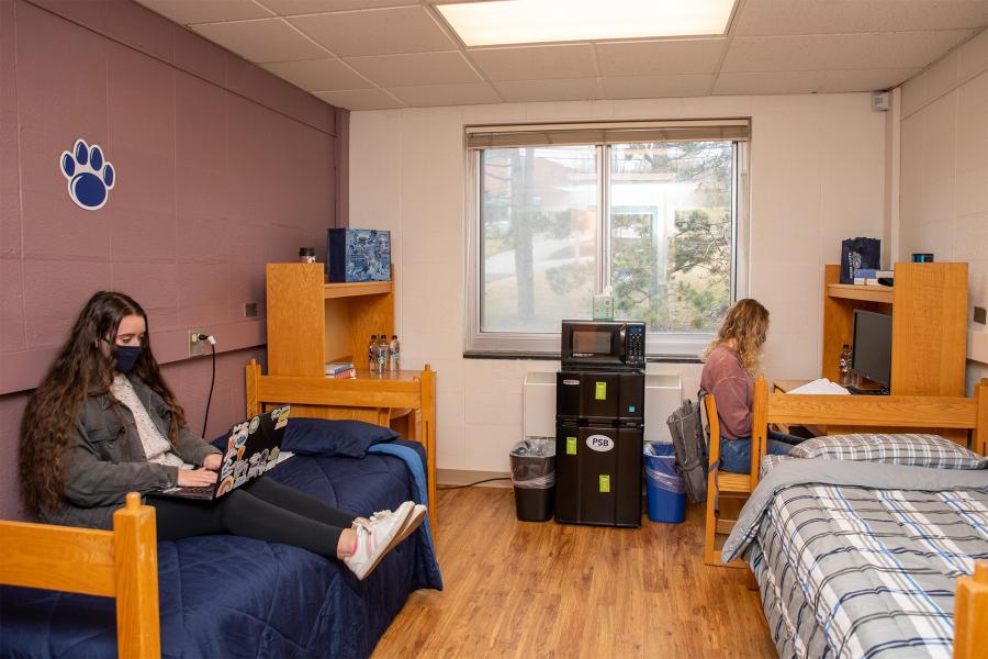 dorm room with students working