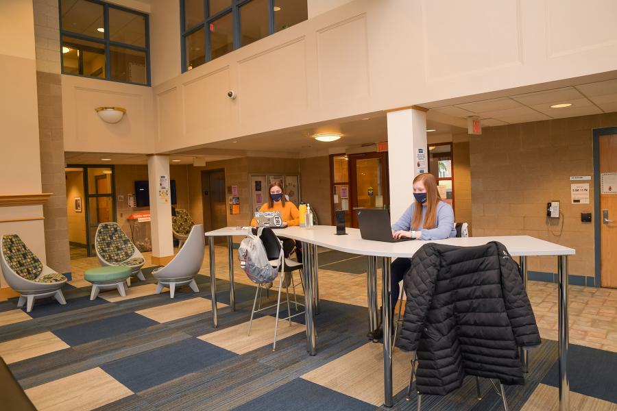 Students at laptops in Ohio Hall lobby