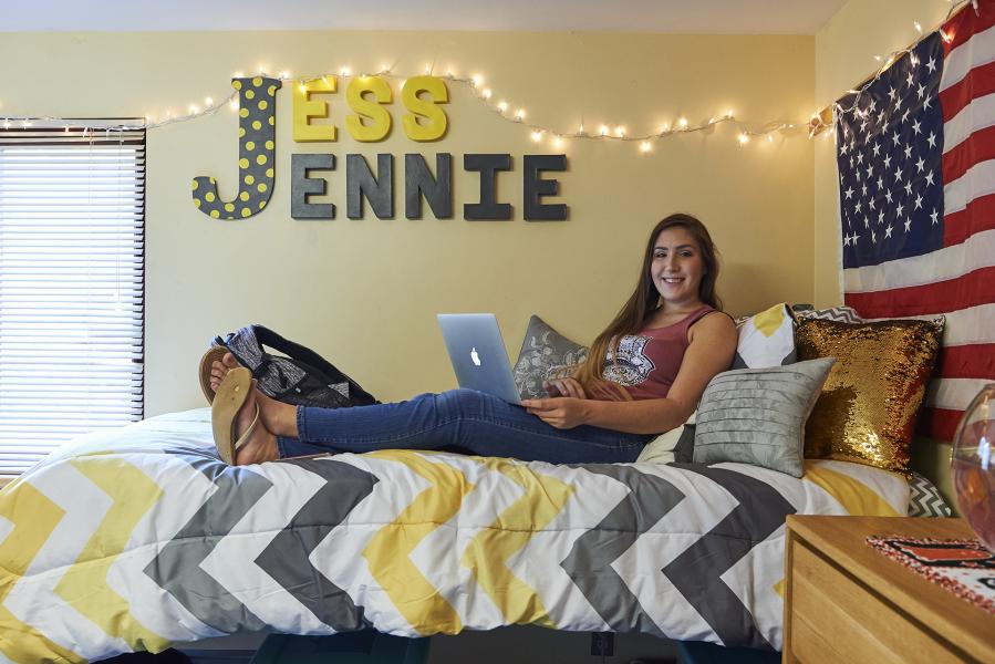 Dorm Room with student on bed