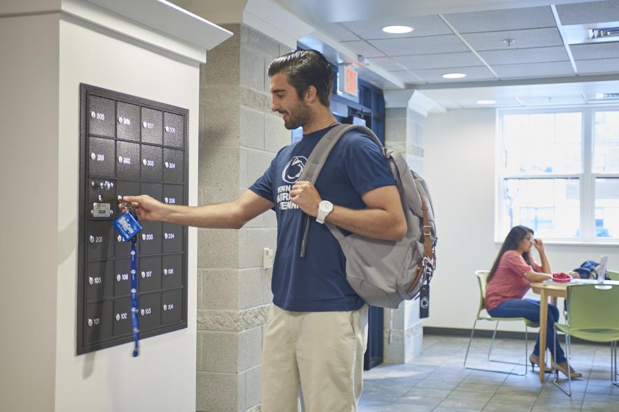 Nittany village mailboxes with student