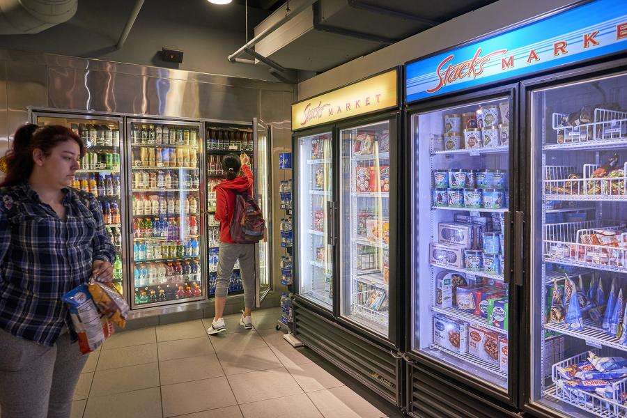 Student browsing coolers at Stacks