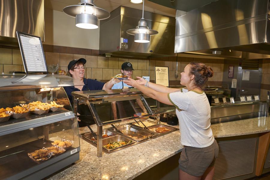 Staff helping a guest at the Homestyle station in Cafe Metro