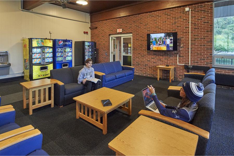 North Halls study lounge with students communicating 