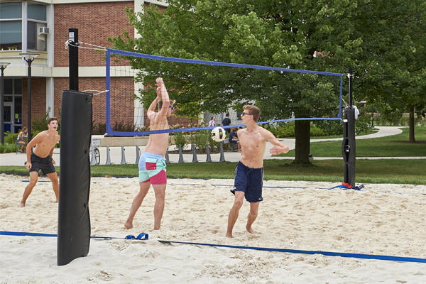 Students playing beach volleyball