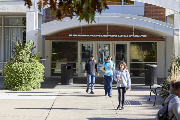 Students walking in and out of Pollock Commons