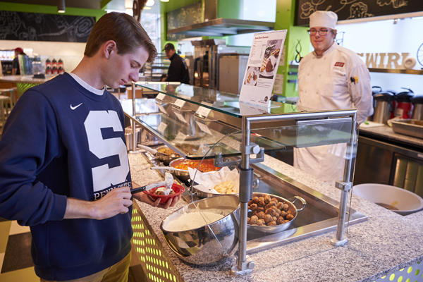 Student getting food in the dining hall