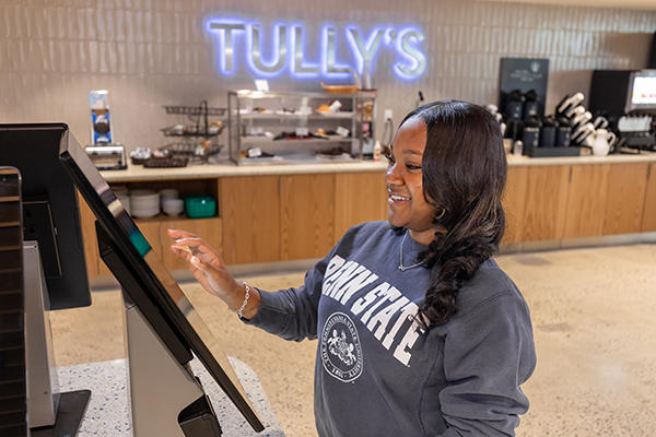 Student orders meal using Tully's kiosk
