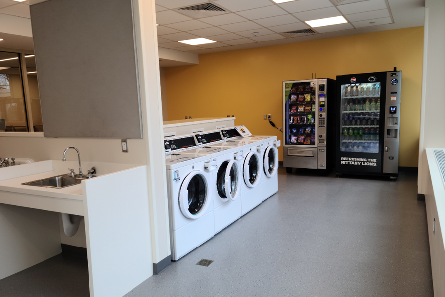 Hastings laundry room that offers several washers, dryers, sink, and vending machines