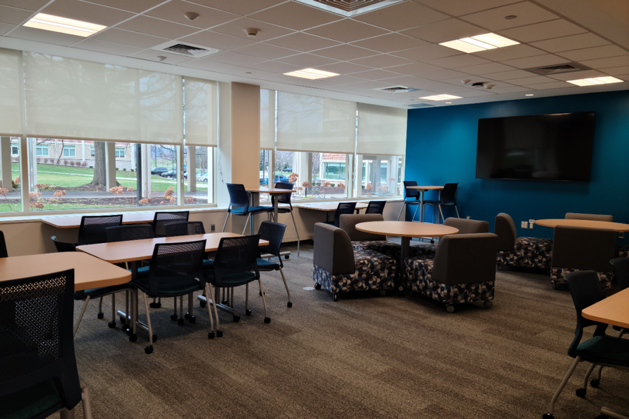 Stone Hall common area showing chairs and tables where students can hang out