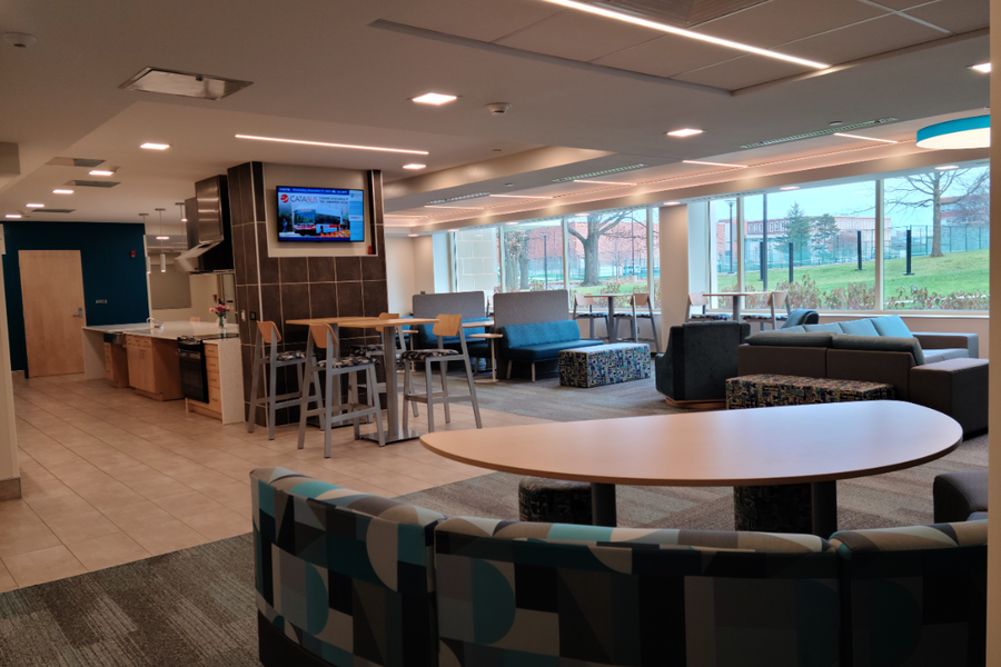 Stone Hall common area showing chairs and tables where students can hang out