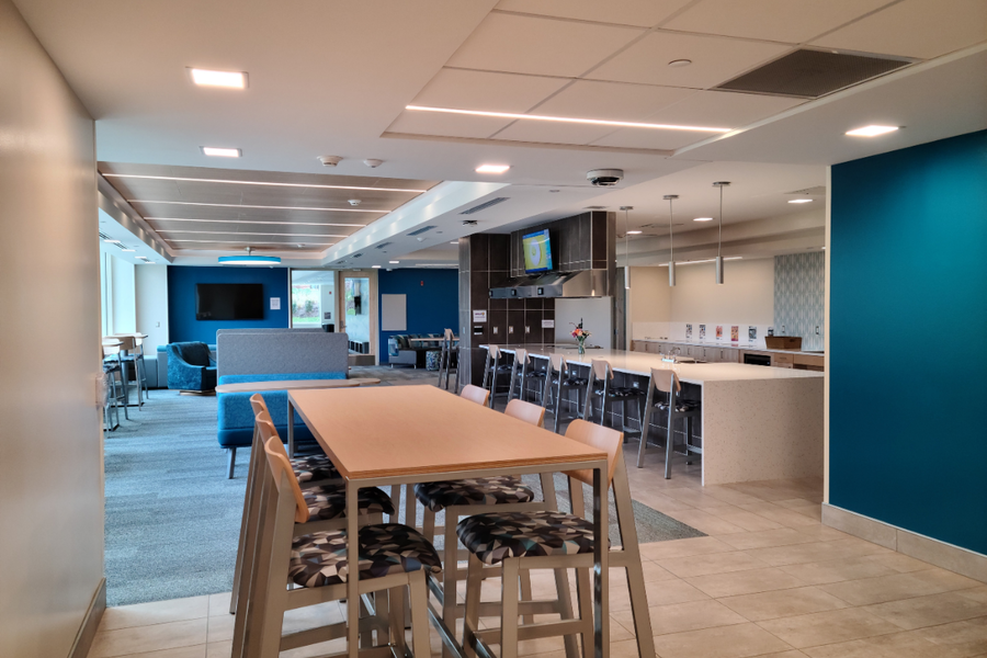 Stone Hall common area showing chairs and tables where students can hang out