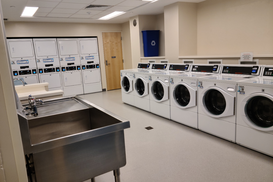 Stone Hall laundry room with washers and dryers