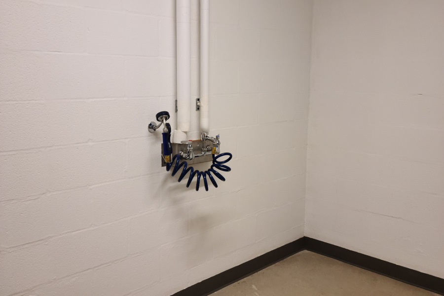 Stone Hall basement locker room with a washing station to use for bikes