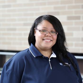 A smiling Jasmaine Price-Thornton in front of the residence hall