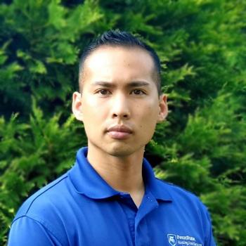 Jerwain Orendain standing in front of trees