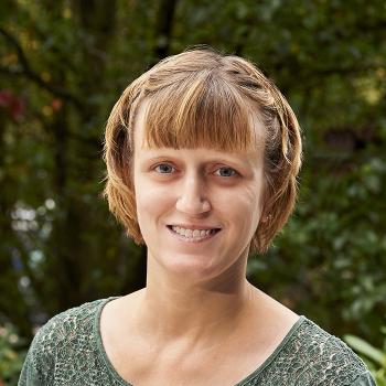 A smiling Wanda Reich in front of a natural backdrop