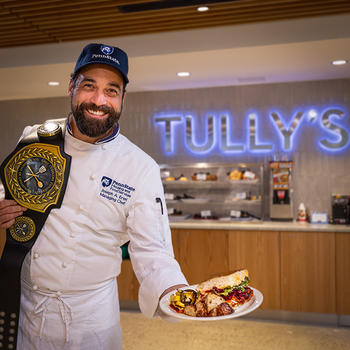 Chef Joe Ertel in front of the Tully's sign