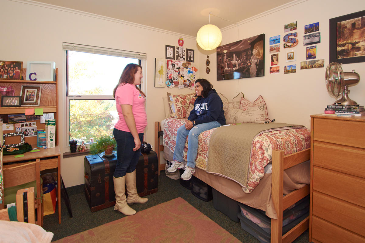 apartment bedroom with students talking