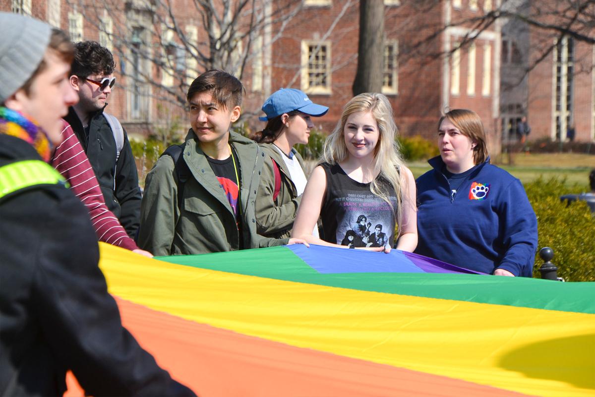 LLC Ally House image of students holding a rainbow flag