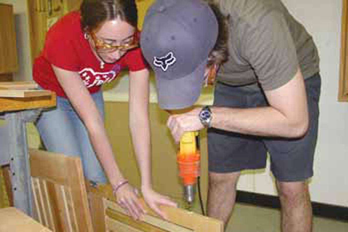 Arts and Architecture LLC two students working on wood project