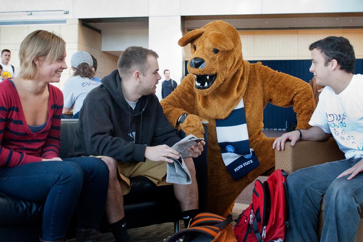 Business and Society House (BASH) 3 students talking with the Nittany Lion