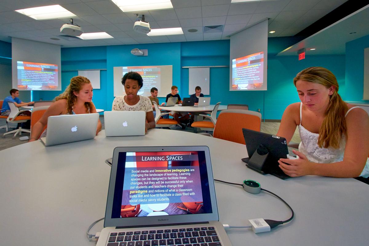 First-Year in Education 3 students behend their laptops