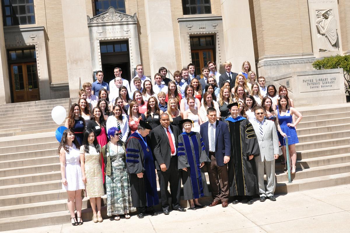 Group of students posing on stairs for photo