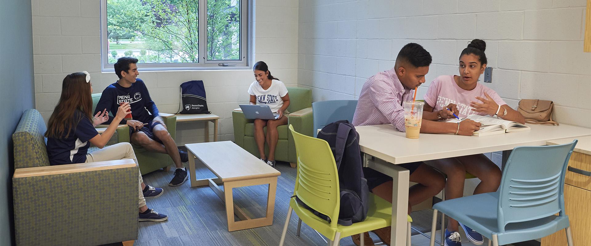 students in living area of the apartment