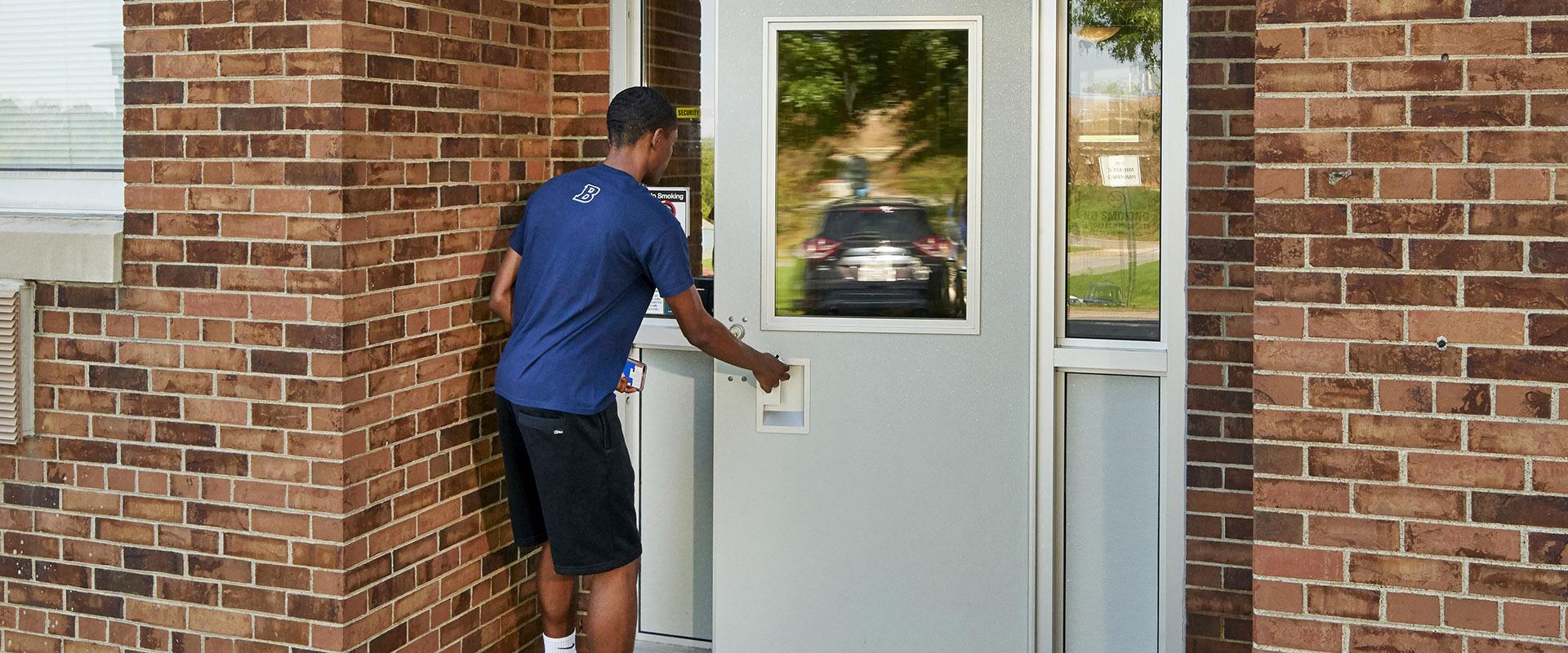 Student entering Harmony Hall