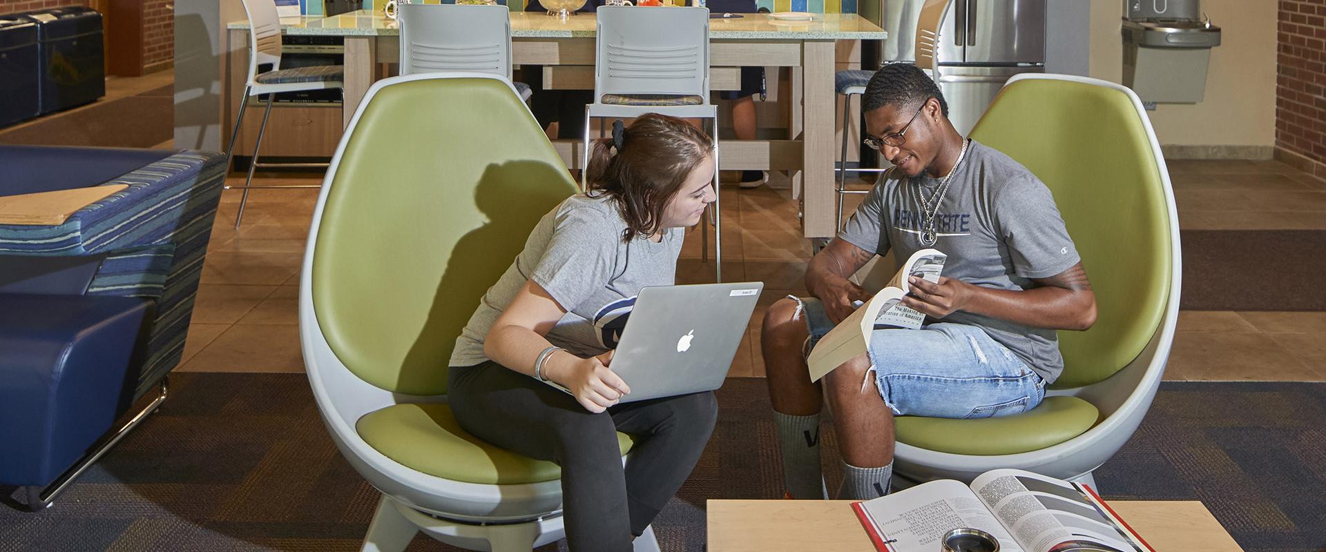 Students in egg chairs in McKeesport lobby
