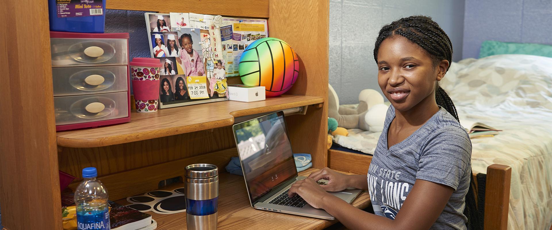 Student at the desk in her Mont Alto Hall room