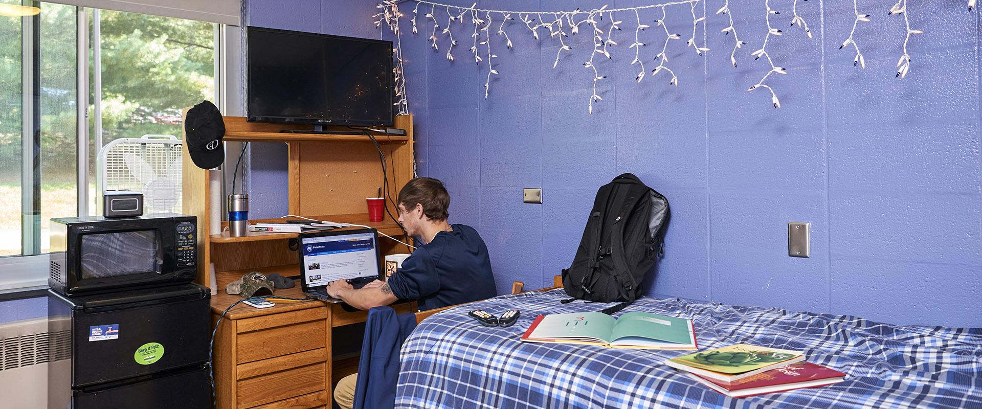 student in his single room in Mont Alto Hall