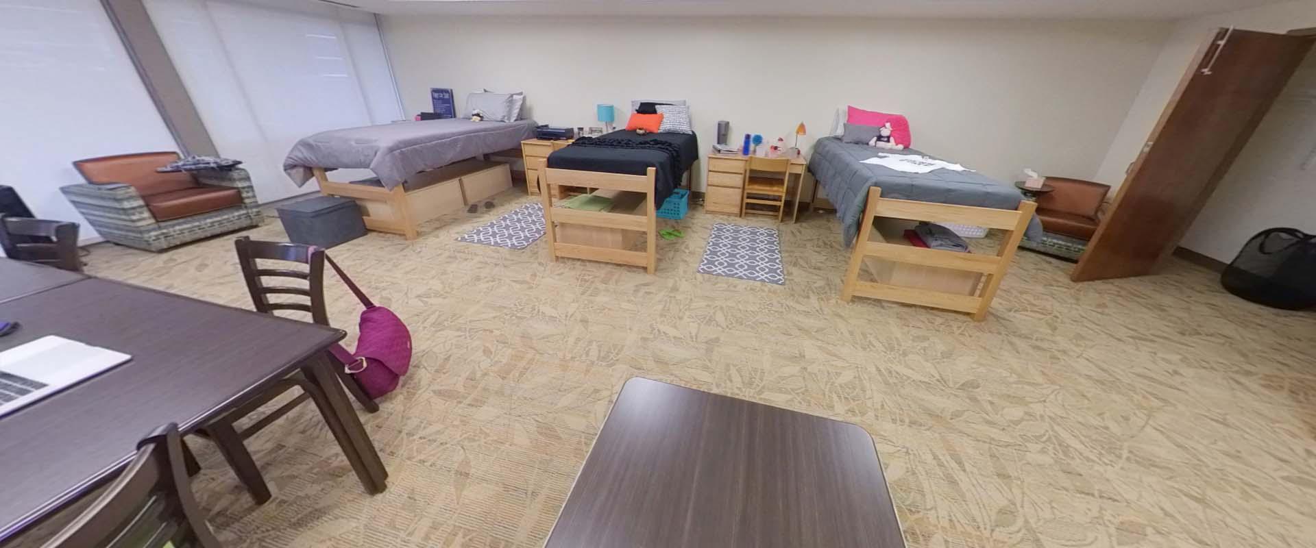 supplemental room showing three beds in a large room