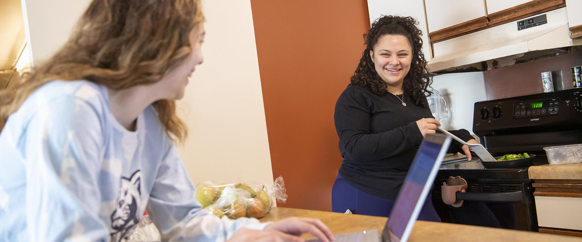 Students cooking in Nittany Apartment kitchen