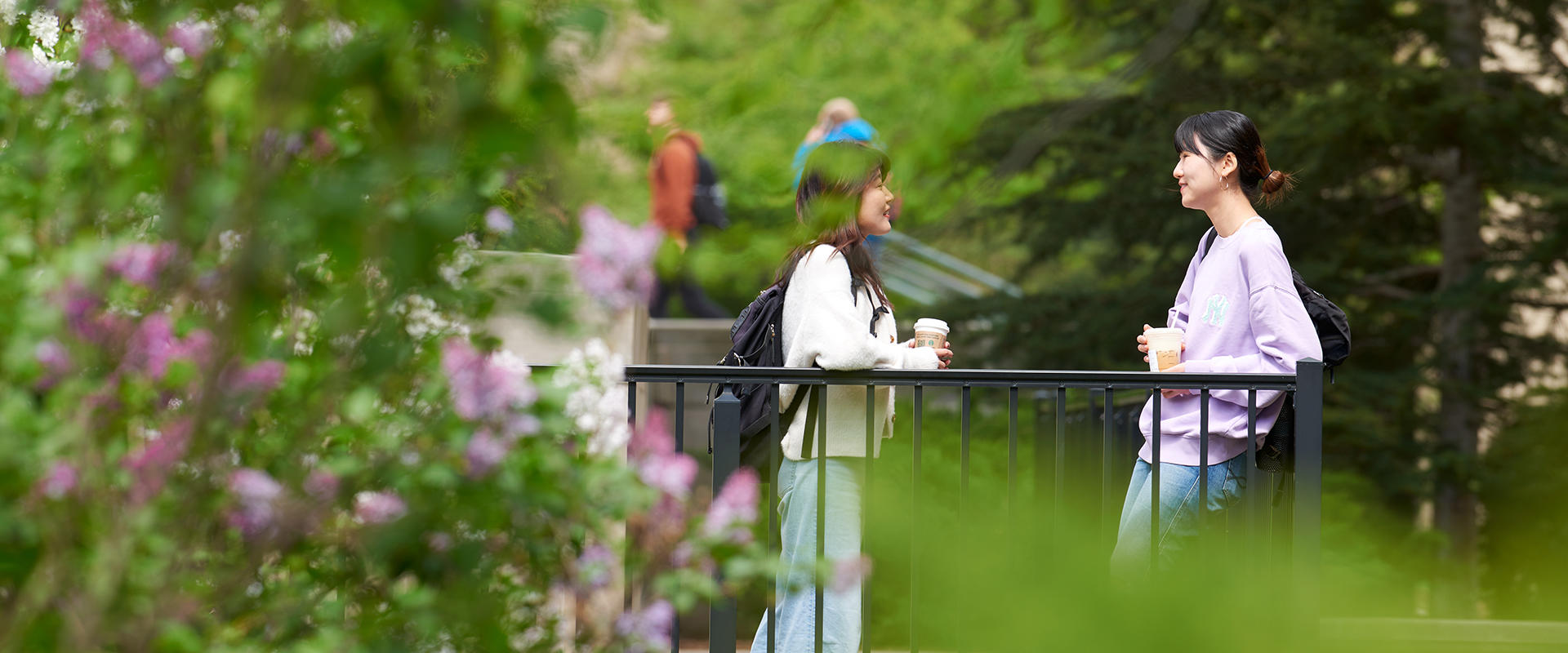 Students visiting with one another on campus