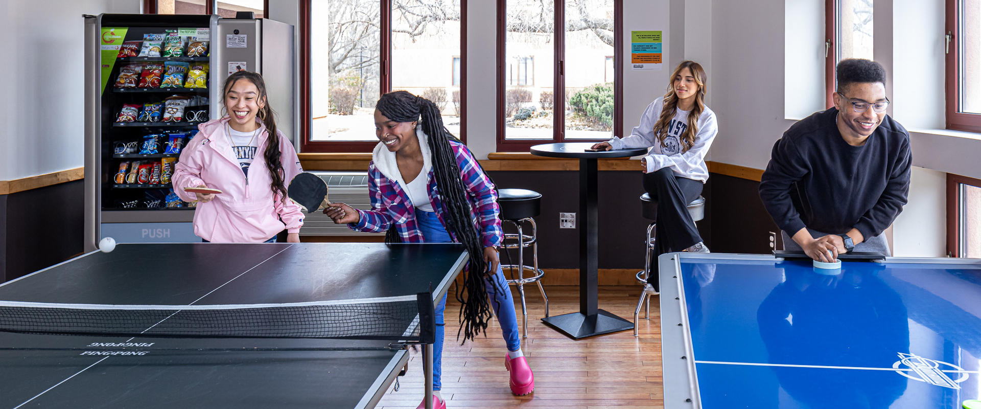 Students playing ping pong and air hocky in student center