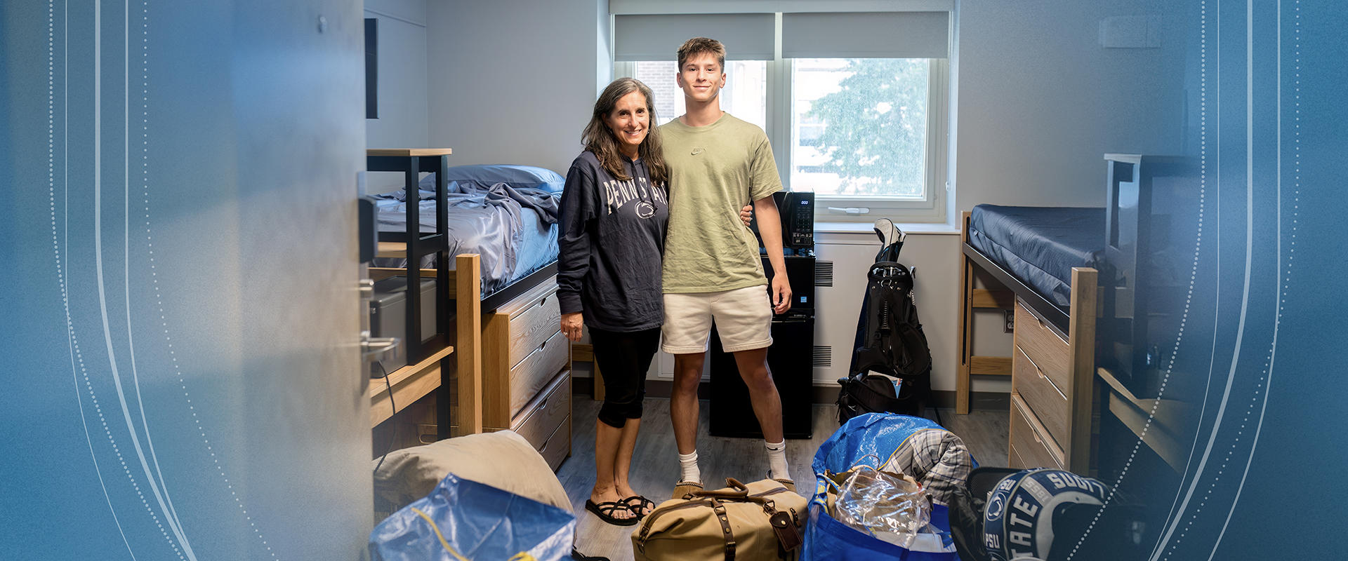 Student and family member pose for a photo during move in.
